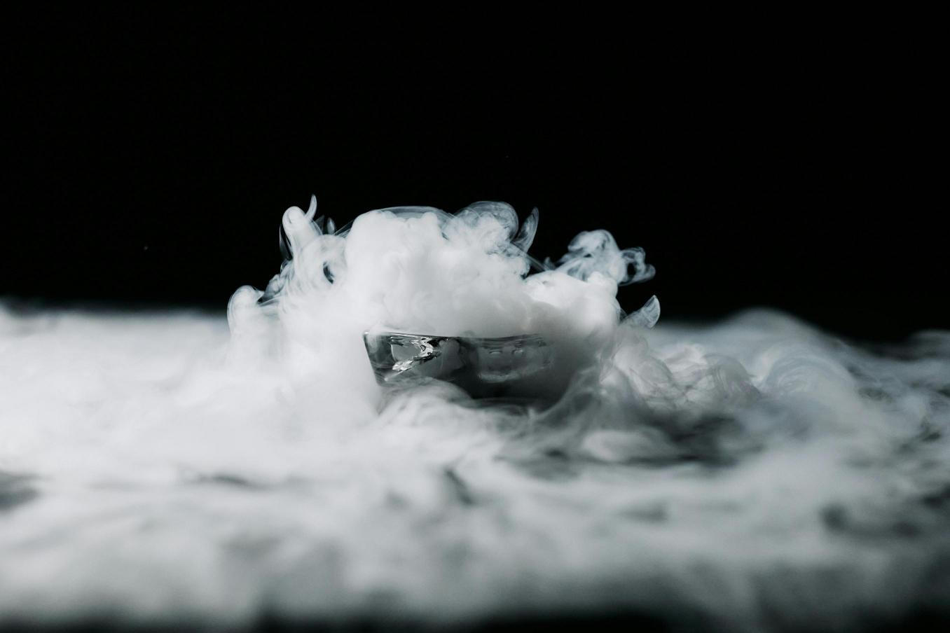 Thick, dramatic fog created by placing dry ice in warm water, perfect for events and stage effects.