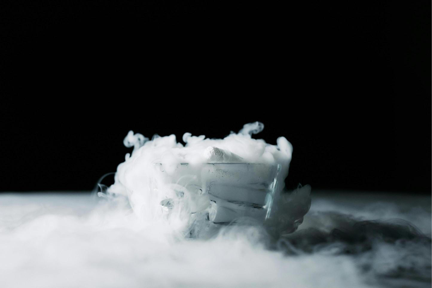 A close-up of fog forming as dry ice reacts with warm water, creating a mystical atmosphere.